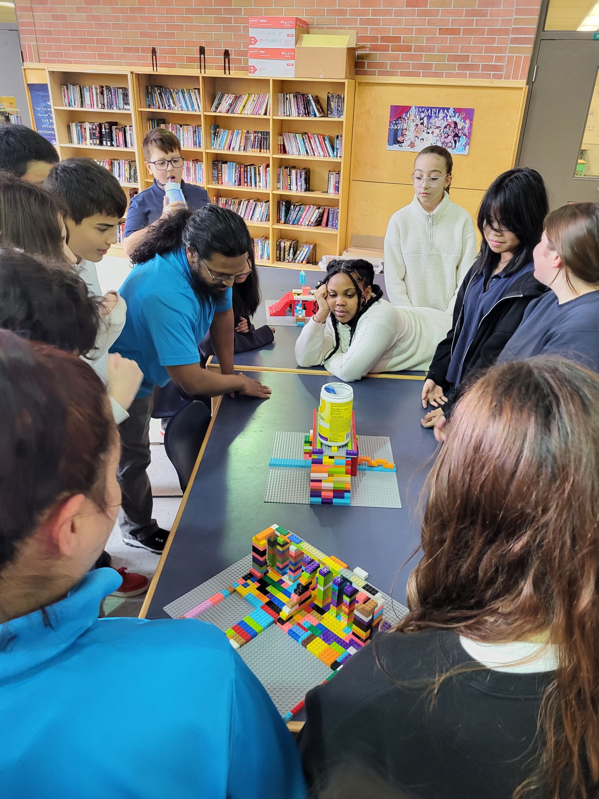 A young boy is sitting at a table playing with toys.