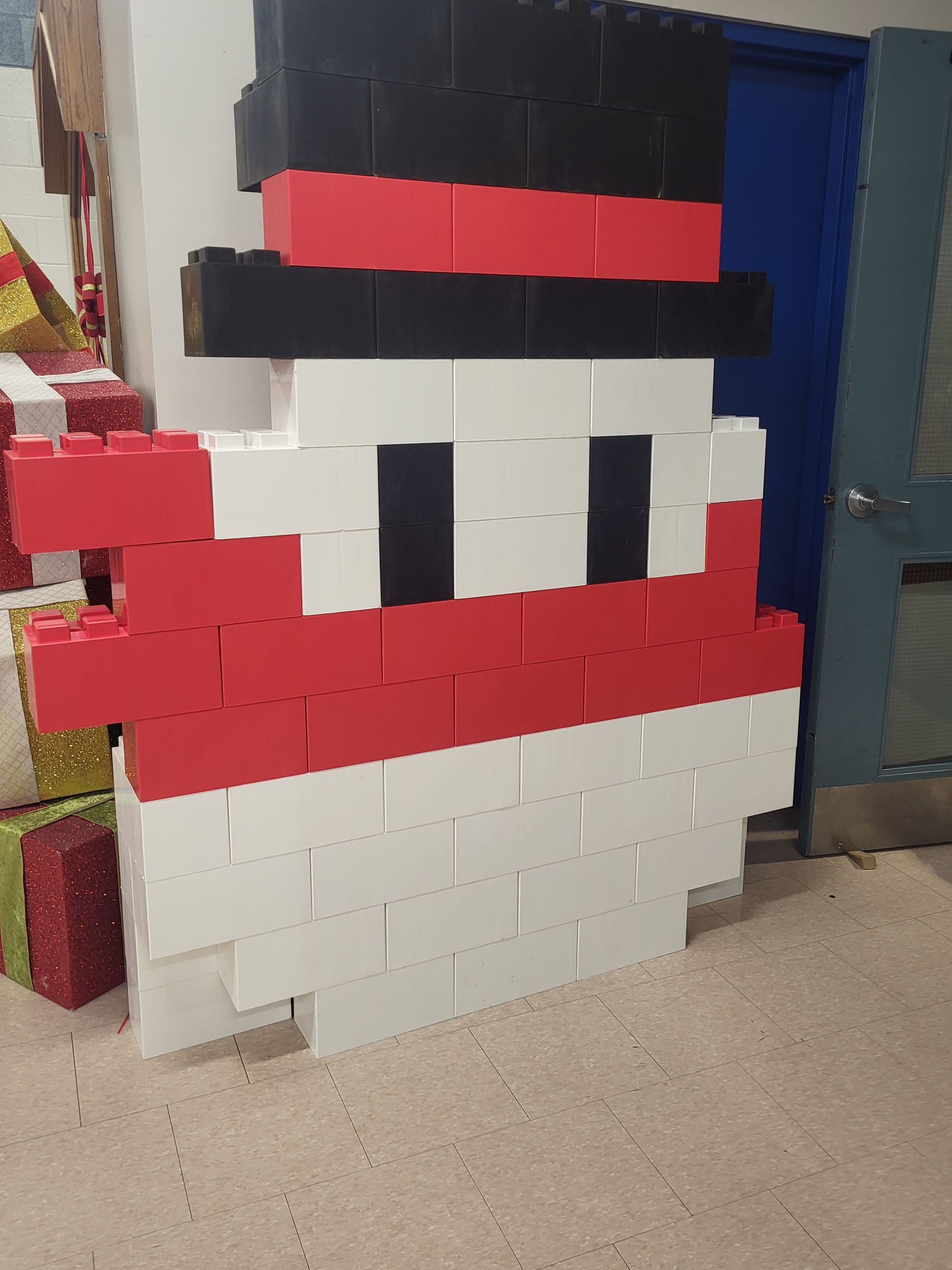 A children's room with tables, chairs, shelves, and a teepee.