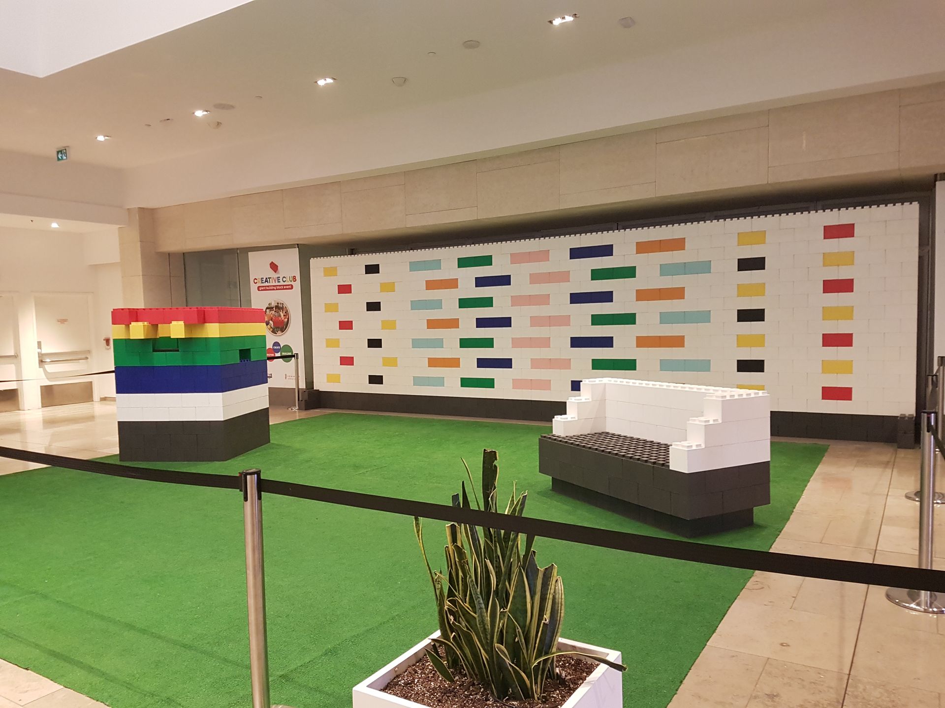 A young boy is sitting at a table playing with toys.