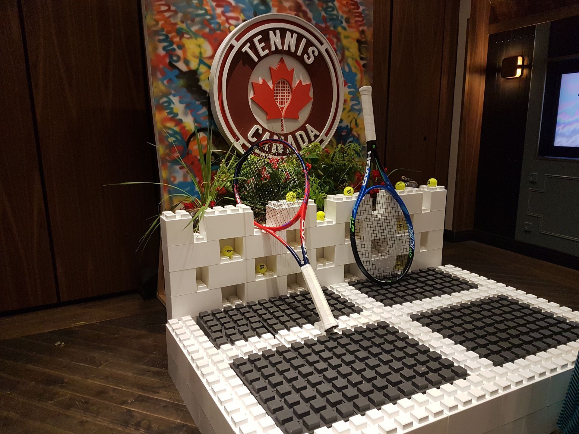 A colorful sculpture made out of lego bricks is sitting on a table.