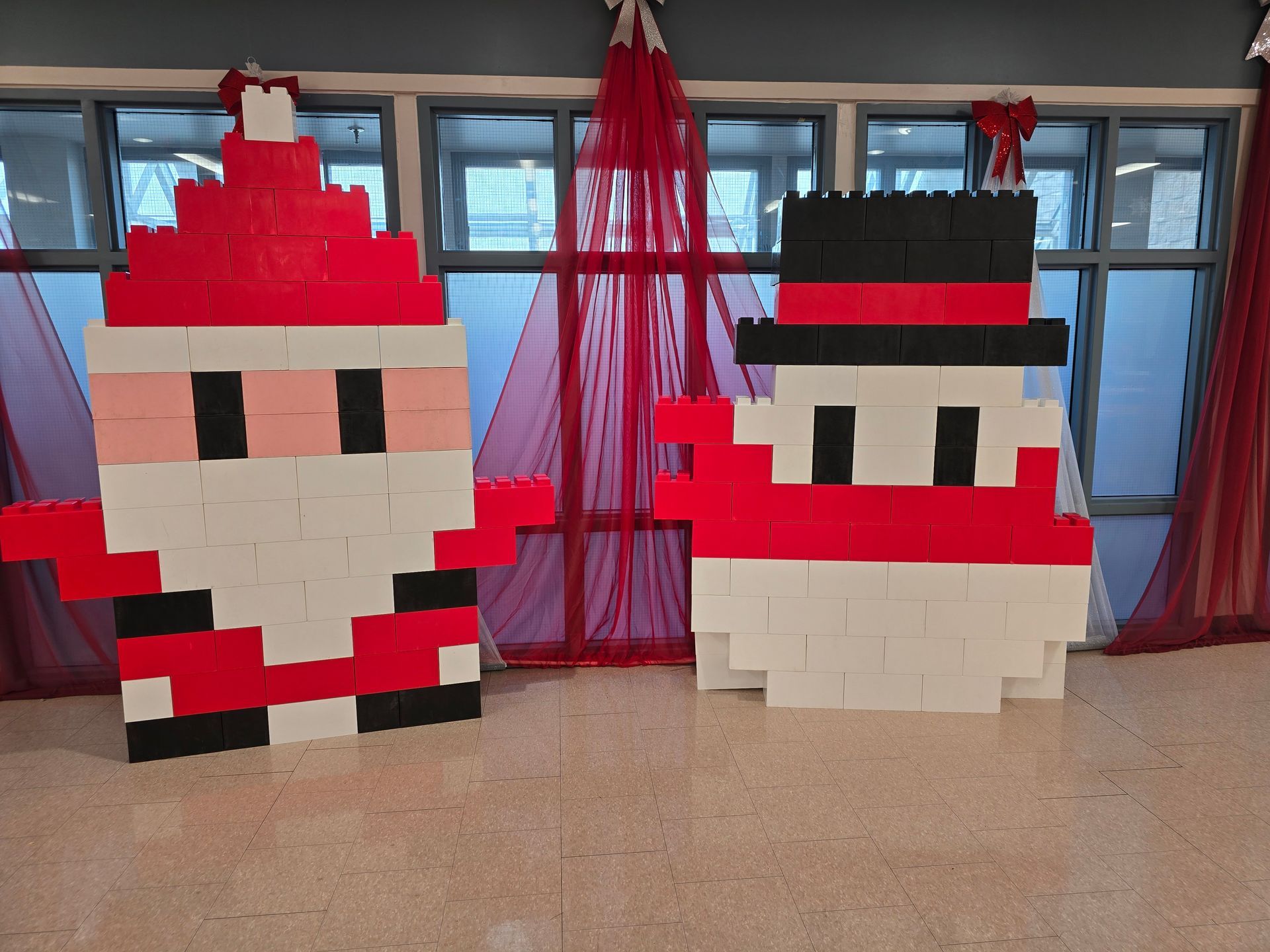 A young boy is sitting at a table playing with toys.