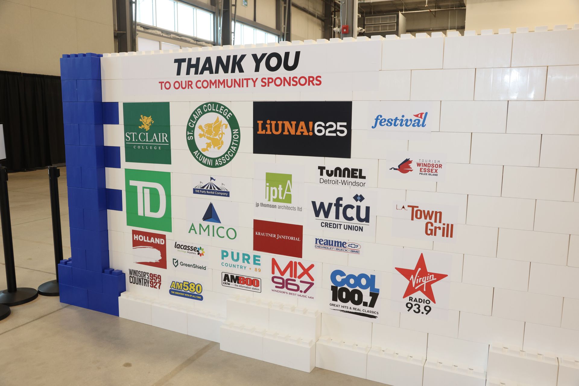 A young boy is sitting at a table playing with toys.