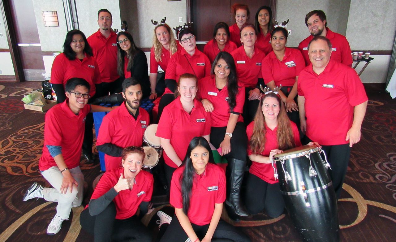 A group of people in red shirts are posing for a picture.