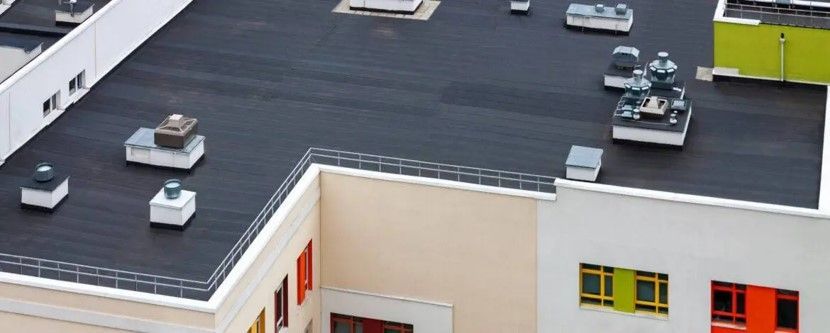 An aerial view of a building with a black roof.