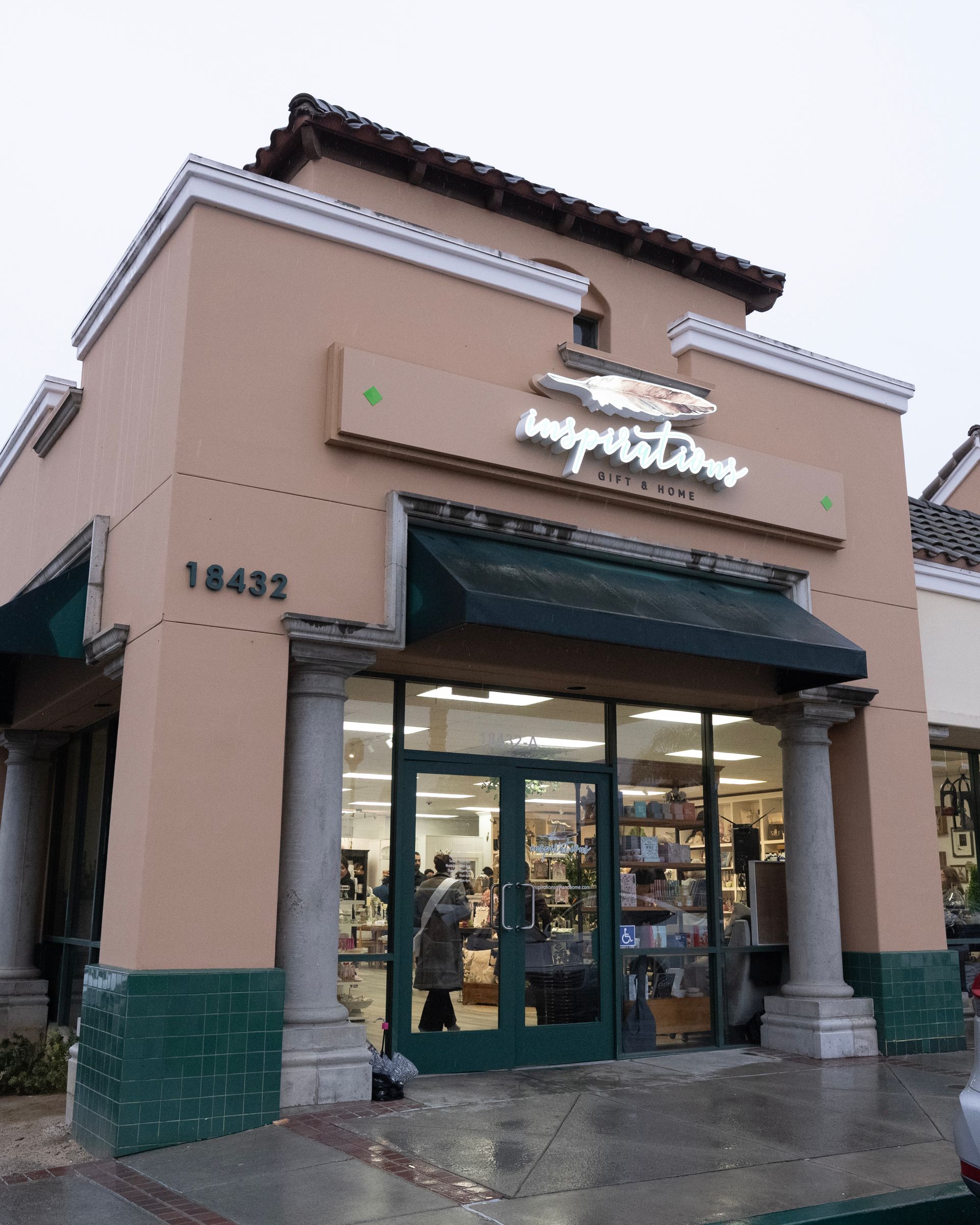 Boutique interior: Display of vintage goods, including hats, purses, decor, and art. Over a wooden counter and shelves.