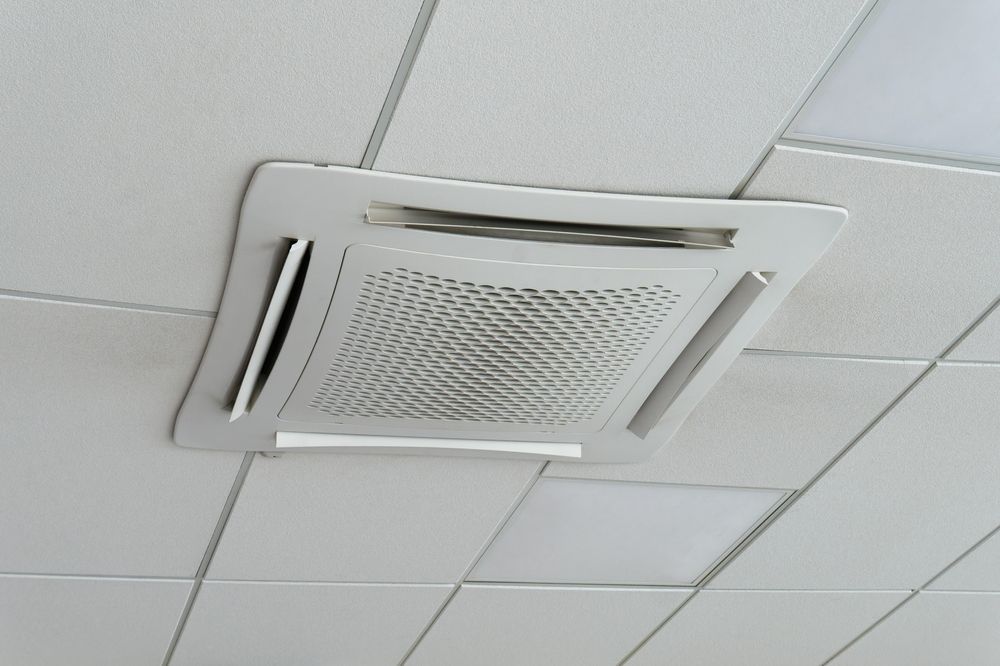 White Ceiling-mounted Air Conditioning Unit With Vents — RedJak Air Conditioning Services in Logan, QLD
