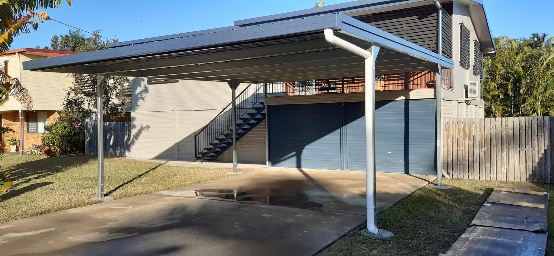 A carport is attached to the side of a house.