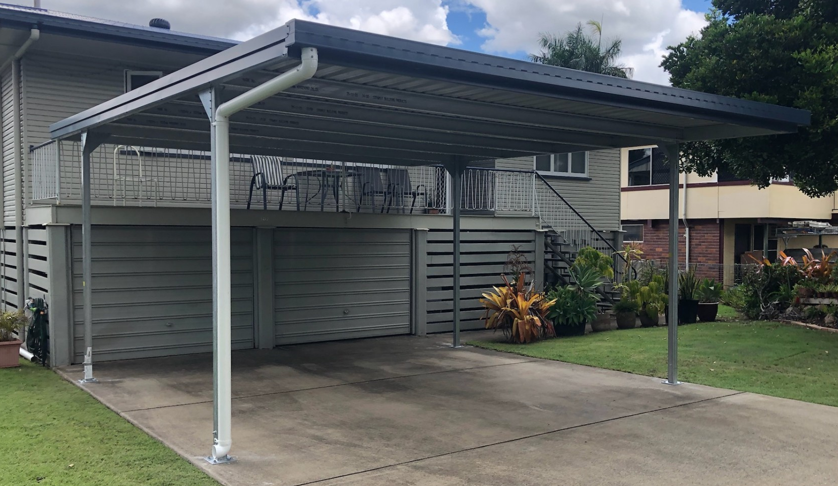 A carport is attached to the side of a house.