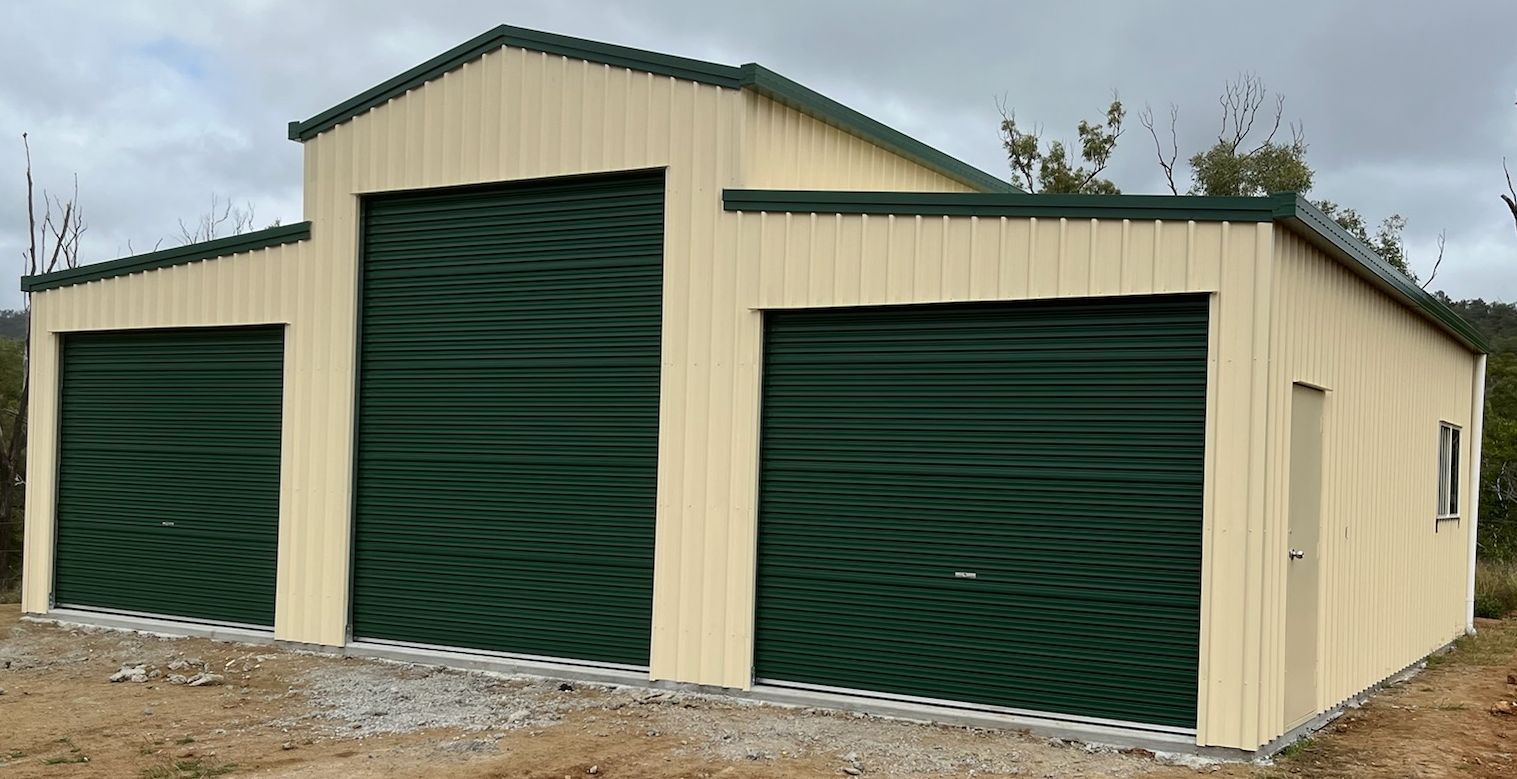 A garage with green doors and a yellow roof