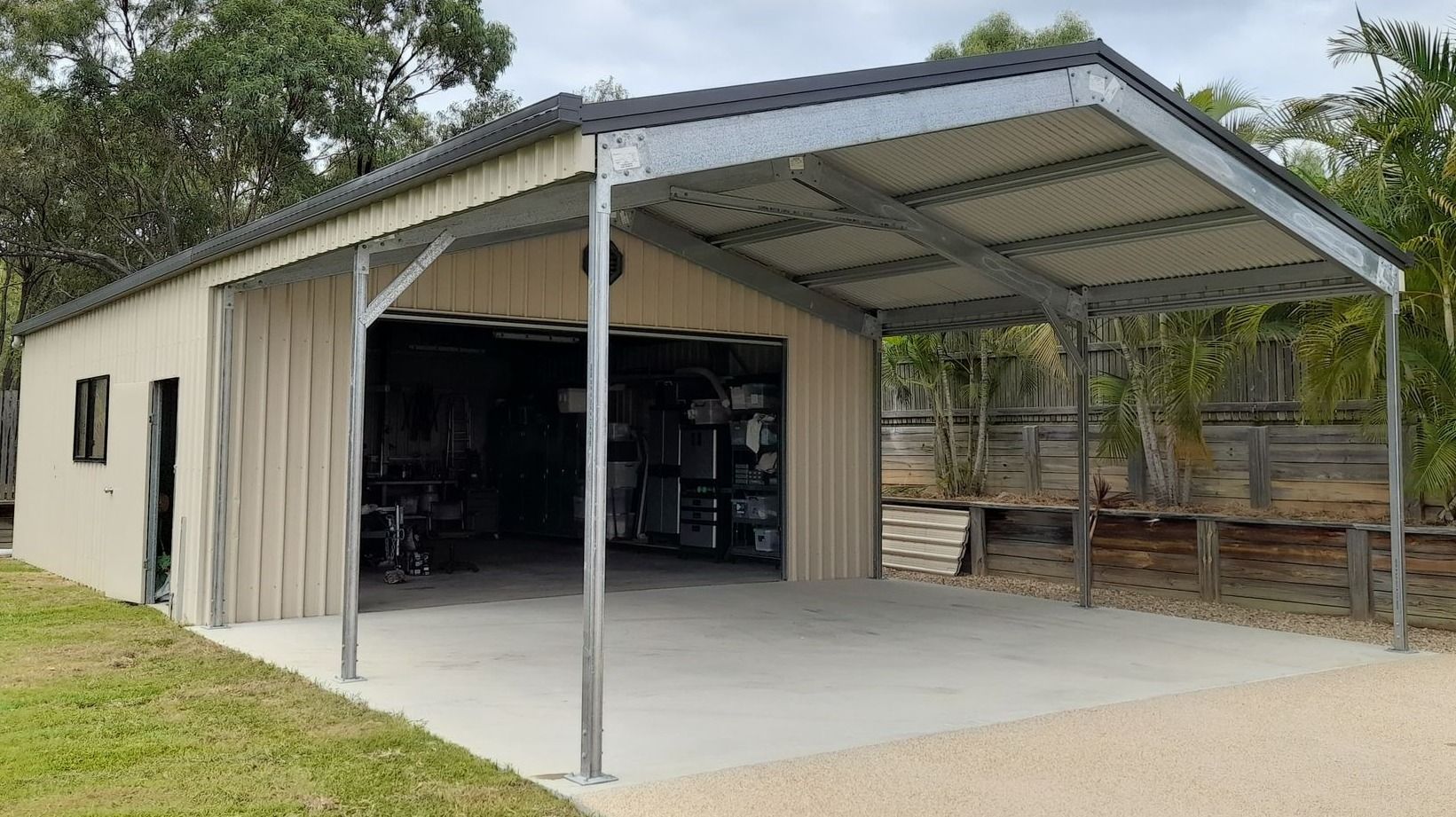 A large metal garage with a canopy over it.