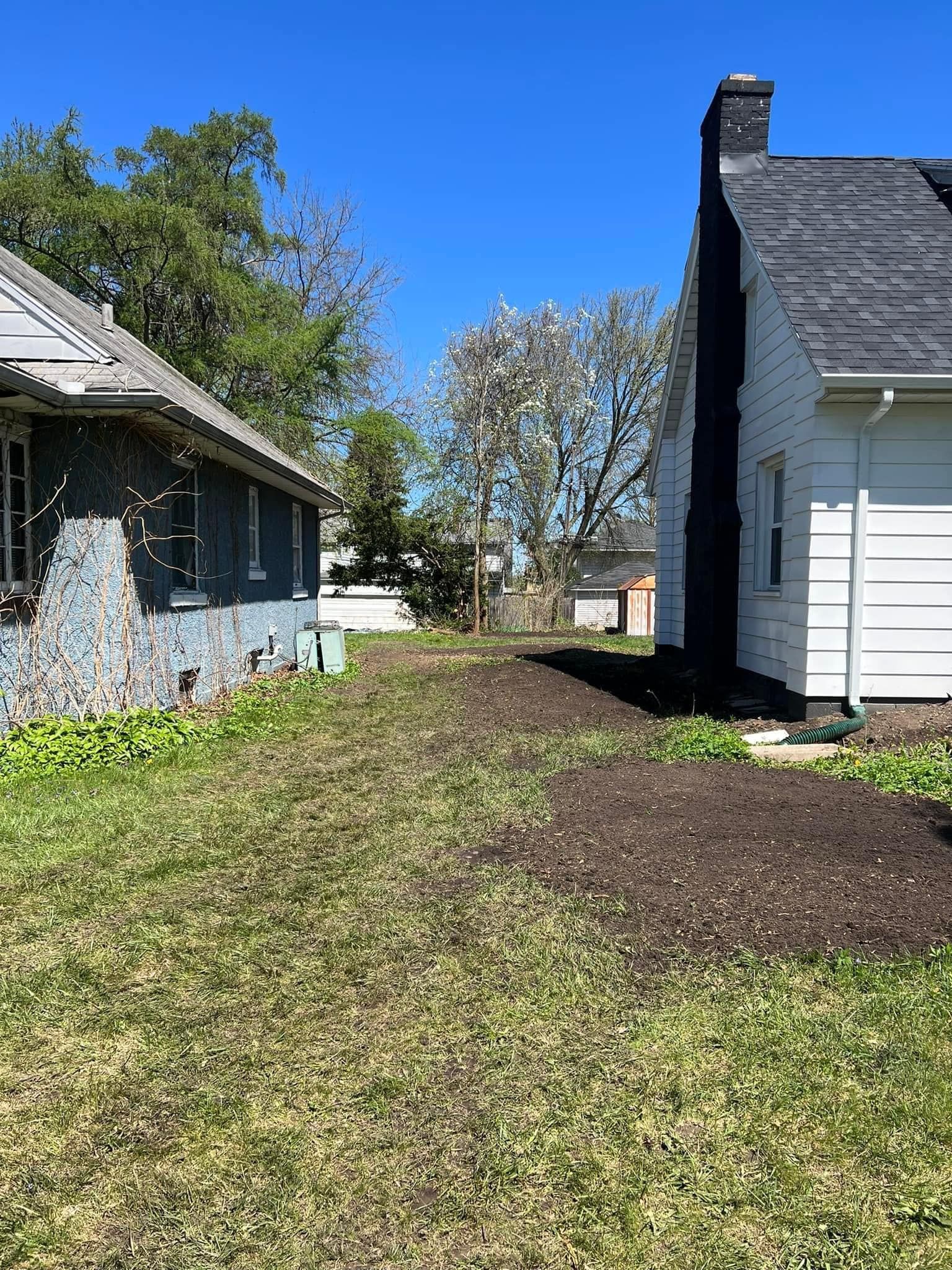 Two houses are sitting next to each other on a lush green lawn.