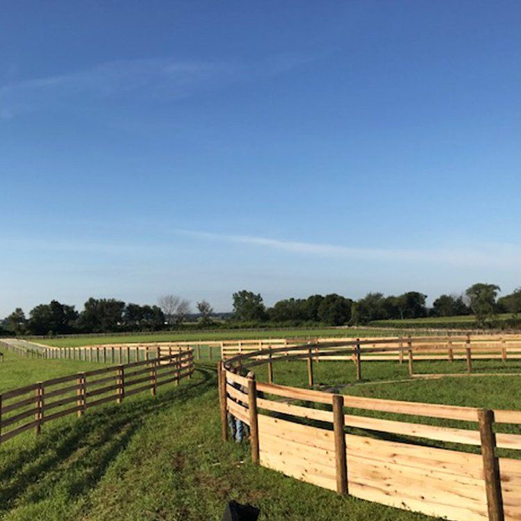 Round Wooden Fence In A Yard — Shelbyville, KY — Shuck Fence Company