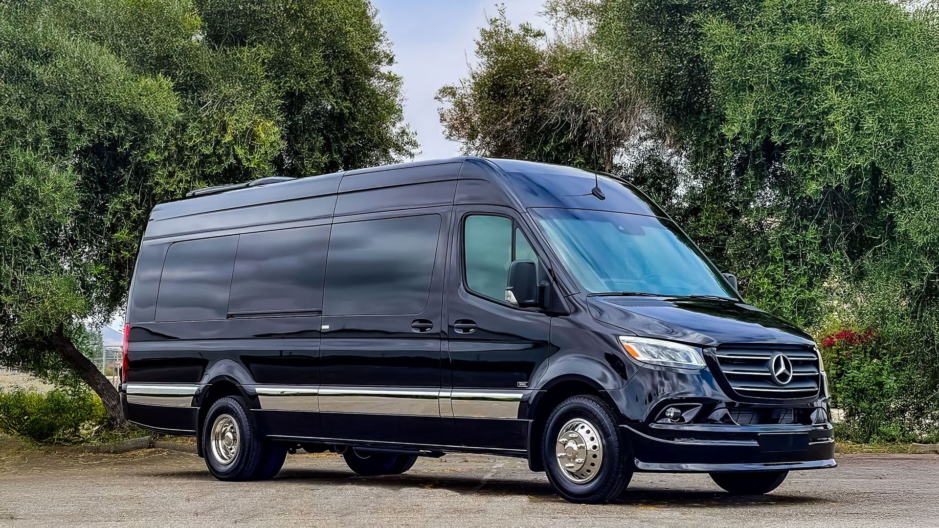 A black mercedes benz s class is parked in a parking lot.
