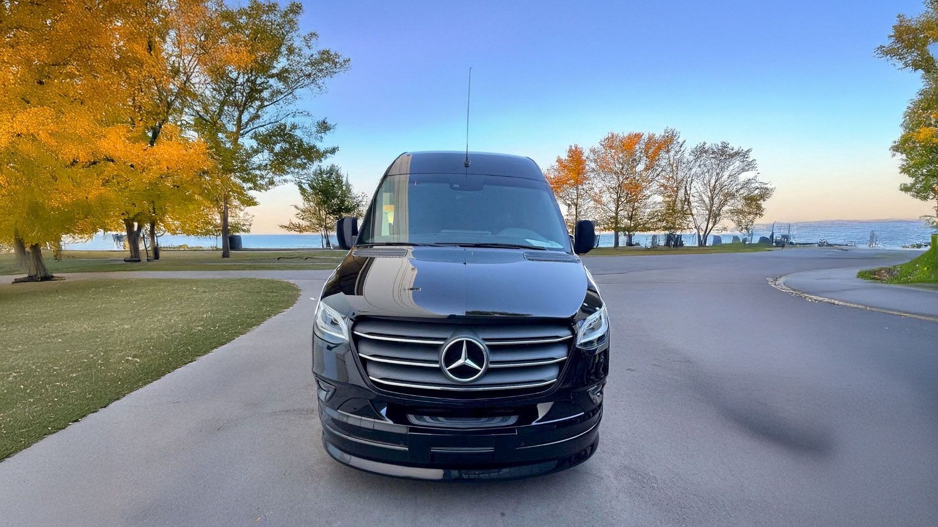 A black mercedes benz s class is parked in a parking lot.