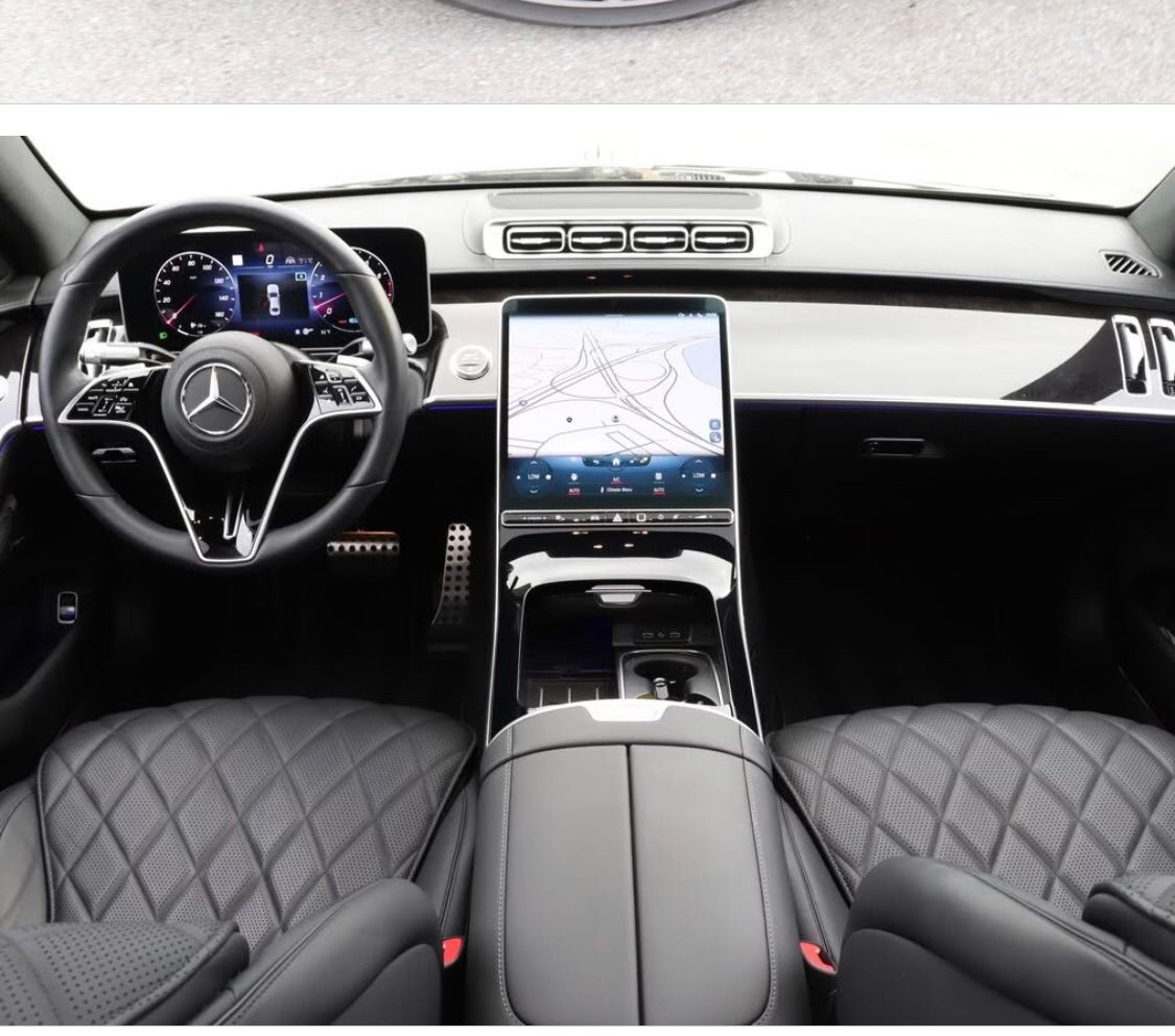 The inside of a car with a tablet on the dashboard.