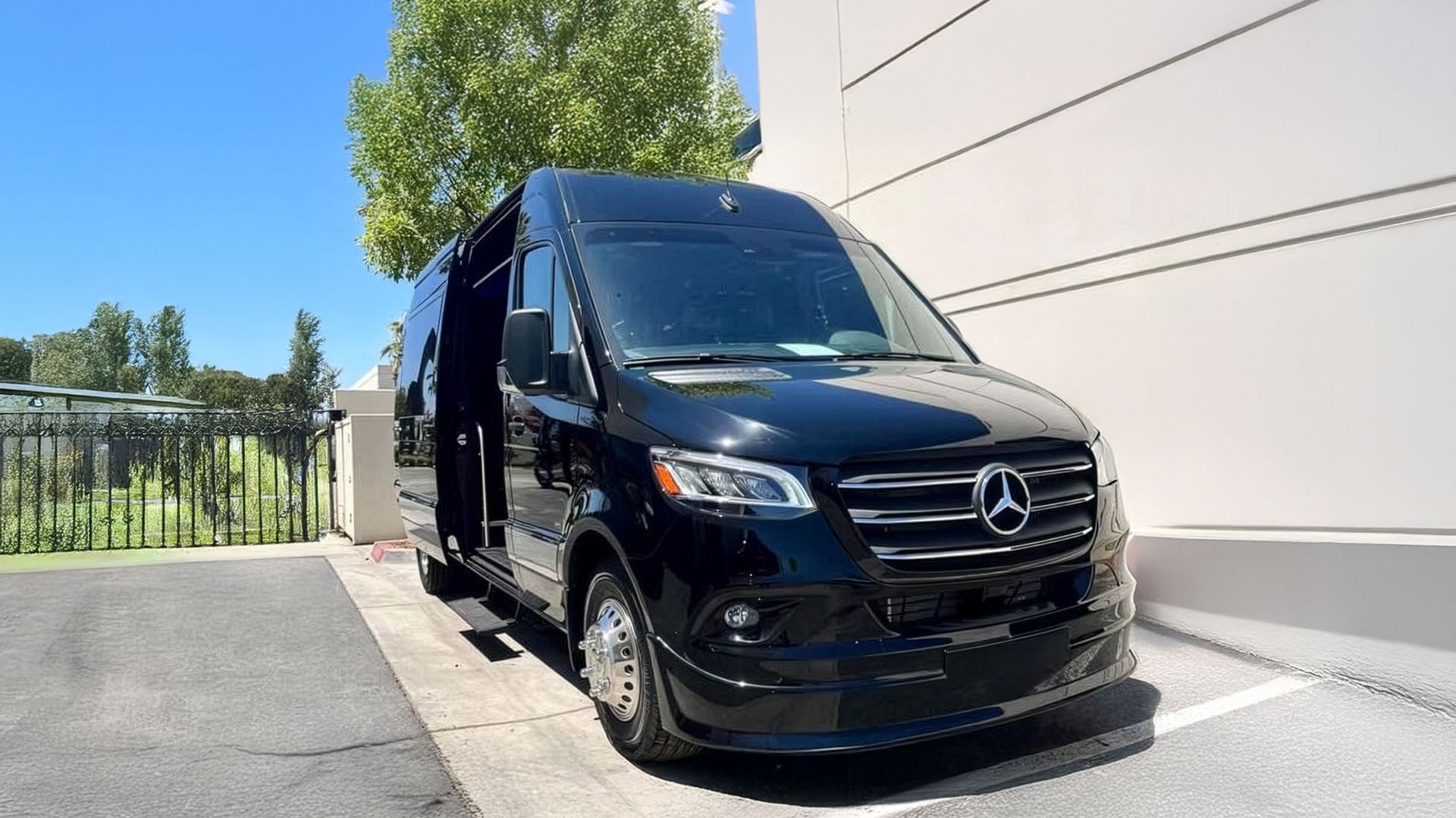 A black mercedes benz s class is parked in a parking lot.