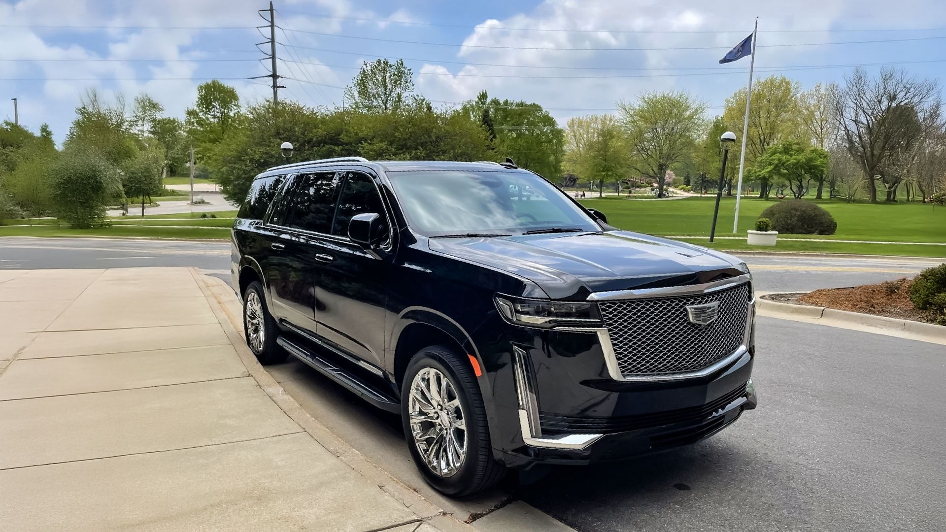 A black mercedes benz s class is parked in a parking lot.