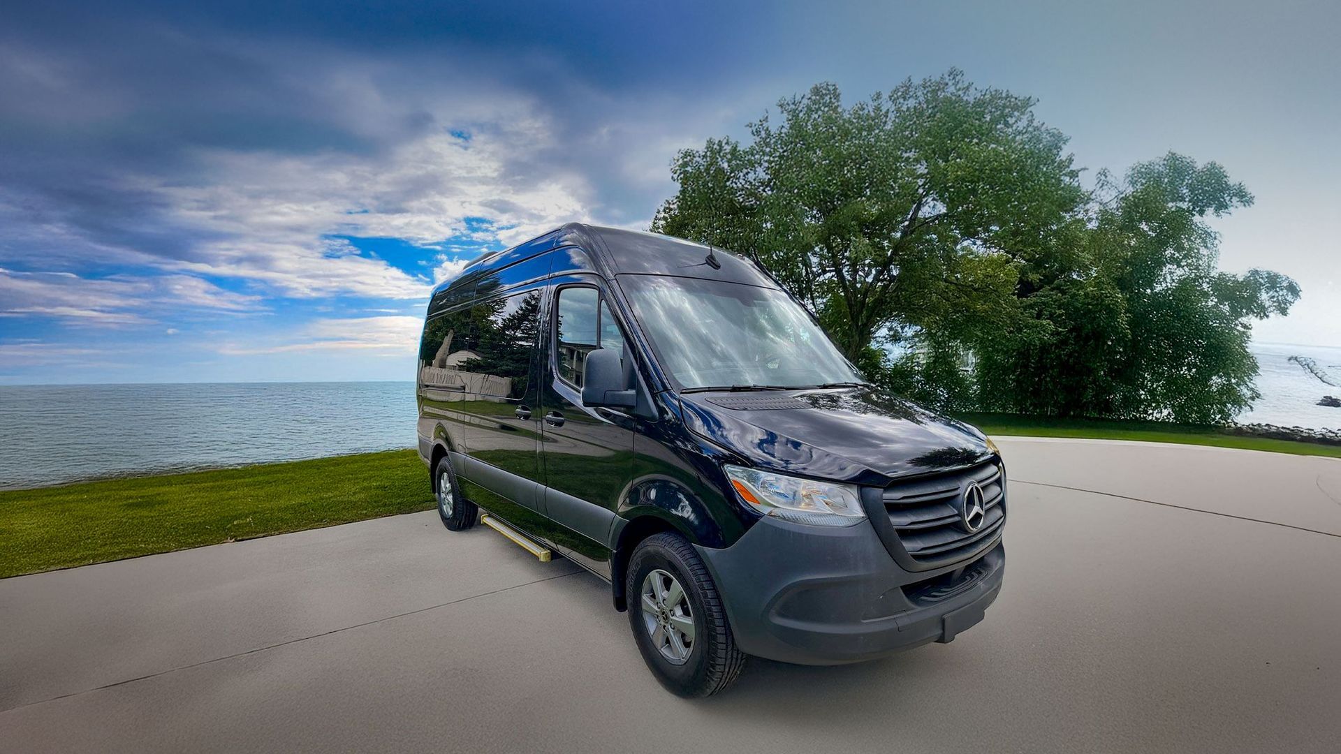 A black mercedes benz s class is parked in a parking lot.