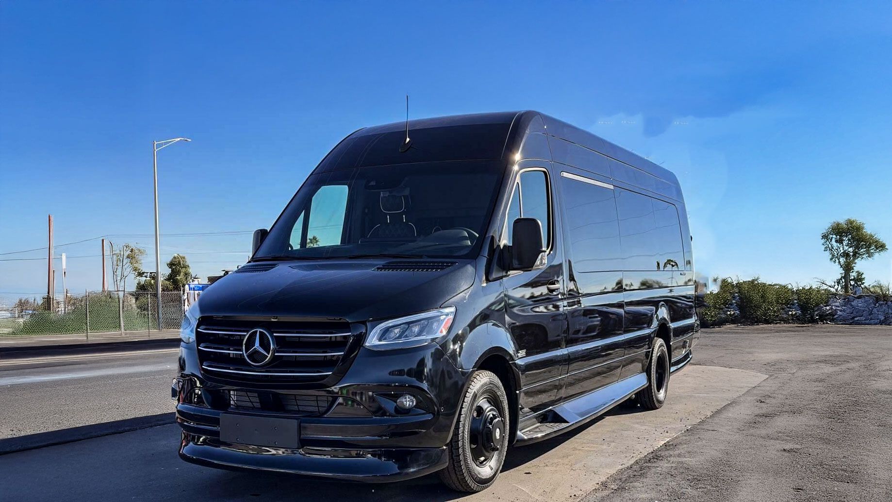A black mercedes benz s class is parked in a parking lot.
