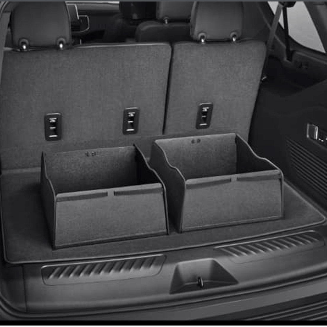 A black and white photo of the trunk of a car