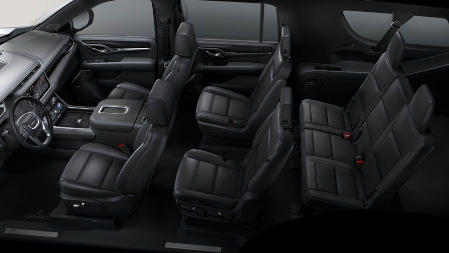 The interior of a gmc yukon is shown in black leather.