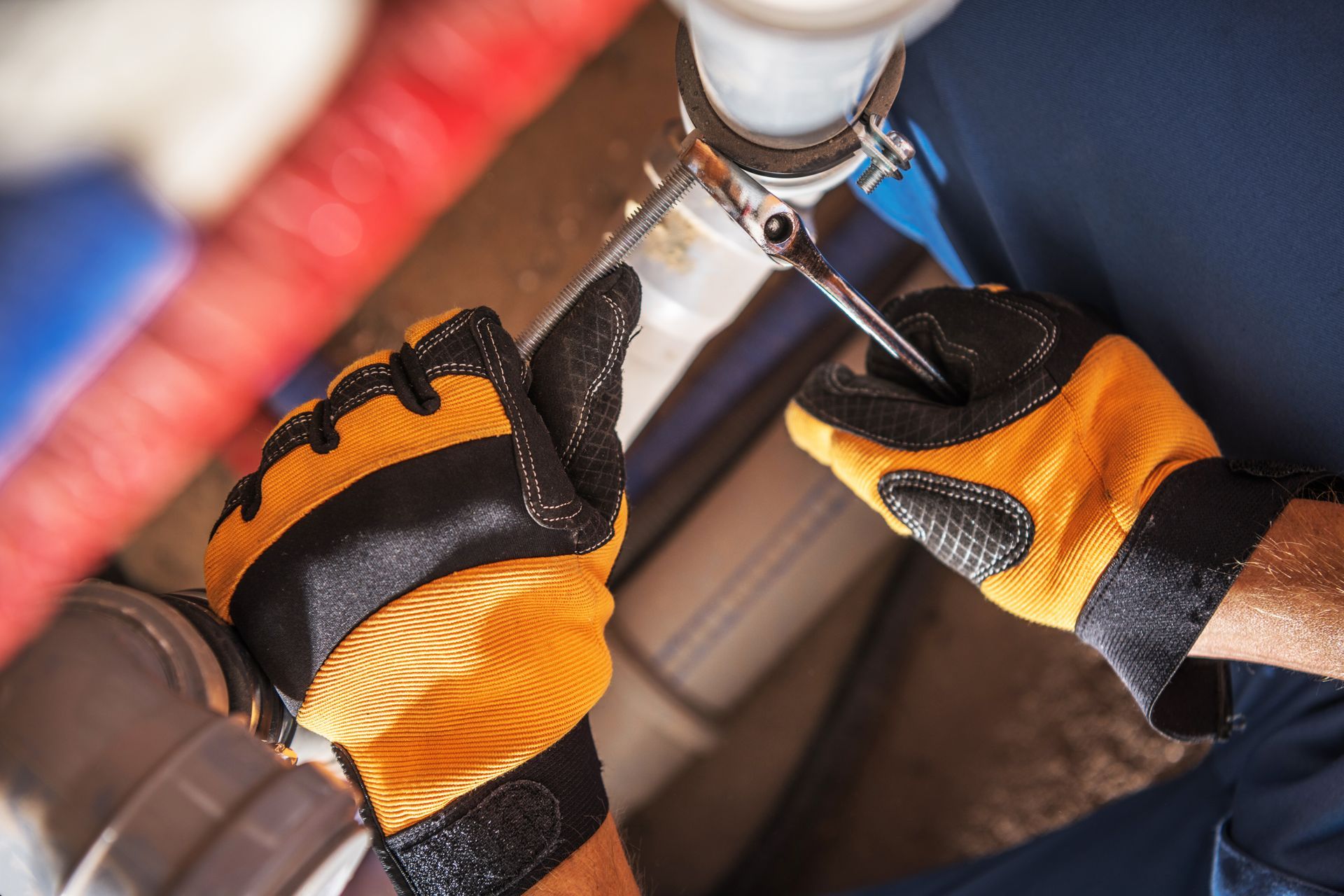 Plumber worker adjusting water and sewage system elements.