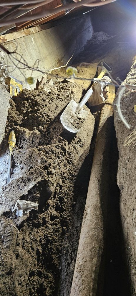 A shovel is sitting on top of a pile of dirt.