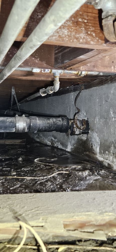 A close up of a pipe in a basement.