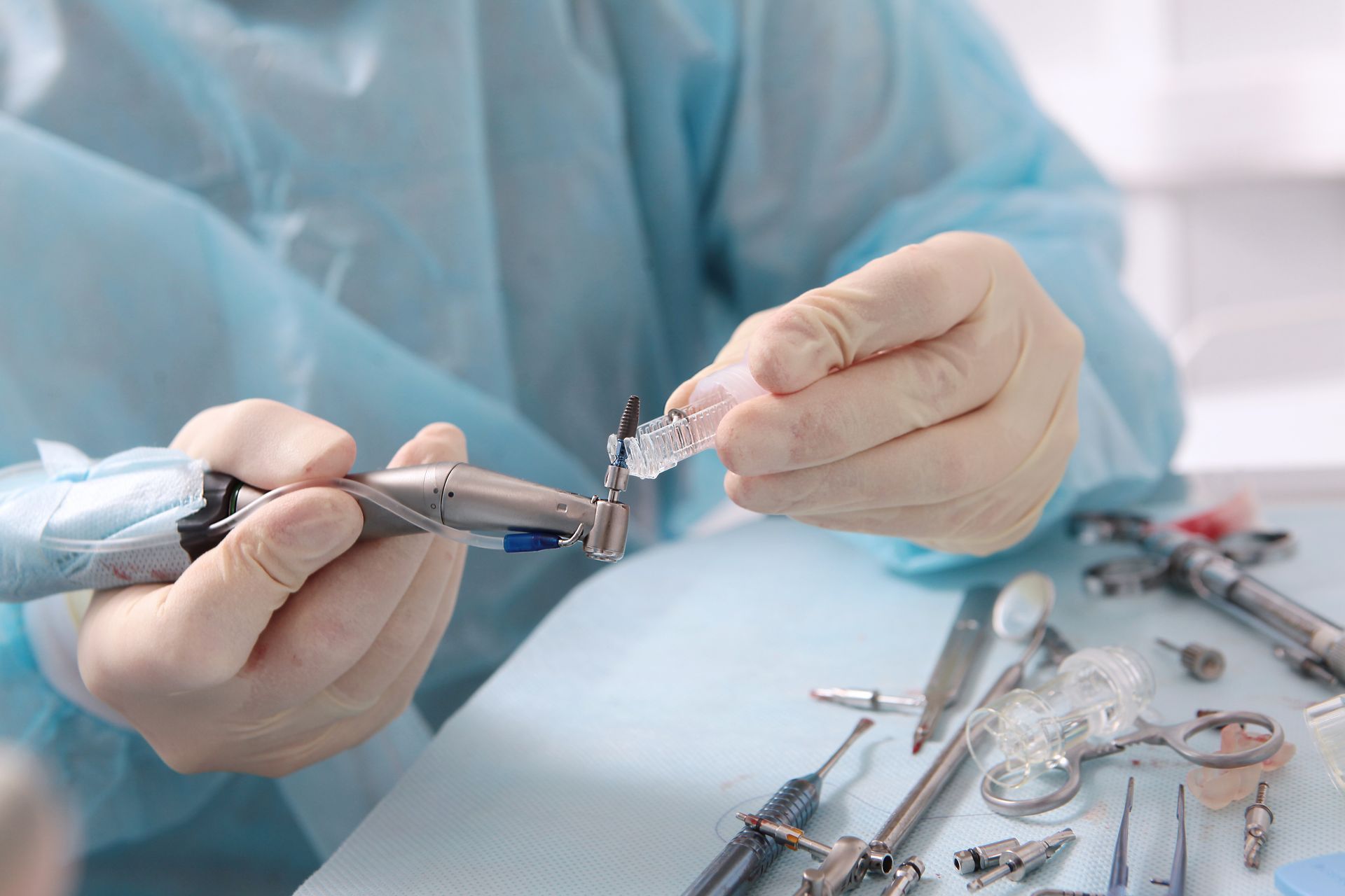 A dentist is preparing to place a dental implant.