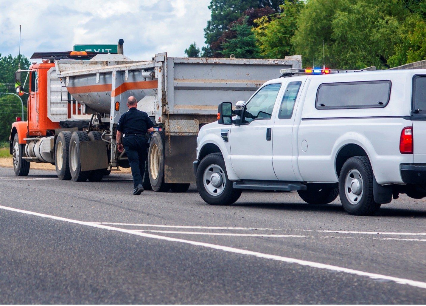 Male traffic enforcer conducting a DOT roadside inspection