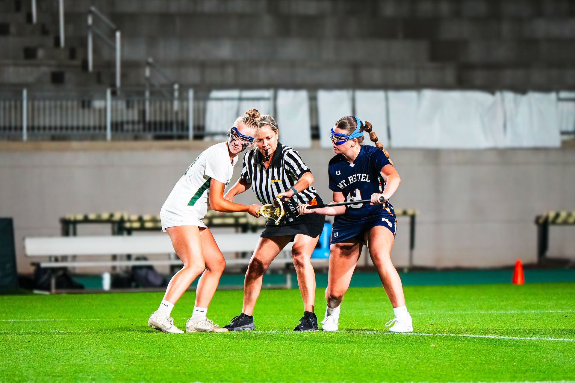 Girls high school lacrosse draw control photo.