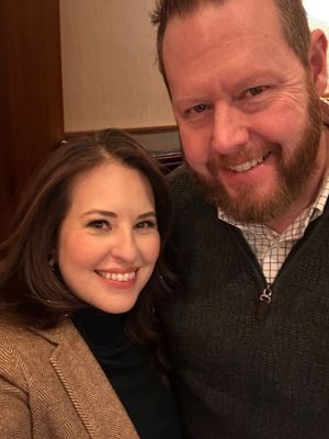 Photo of Cathy and Travis, the owners of Luxe Cosmetic Studios, smiling together and showcasing their dedication to the business.