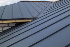 A close up of a gray metal roof on a house under construction.