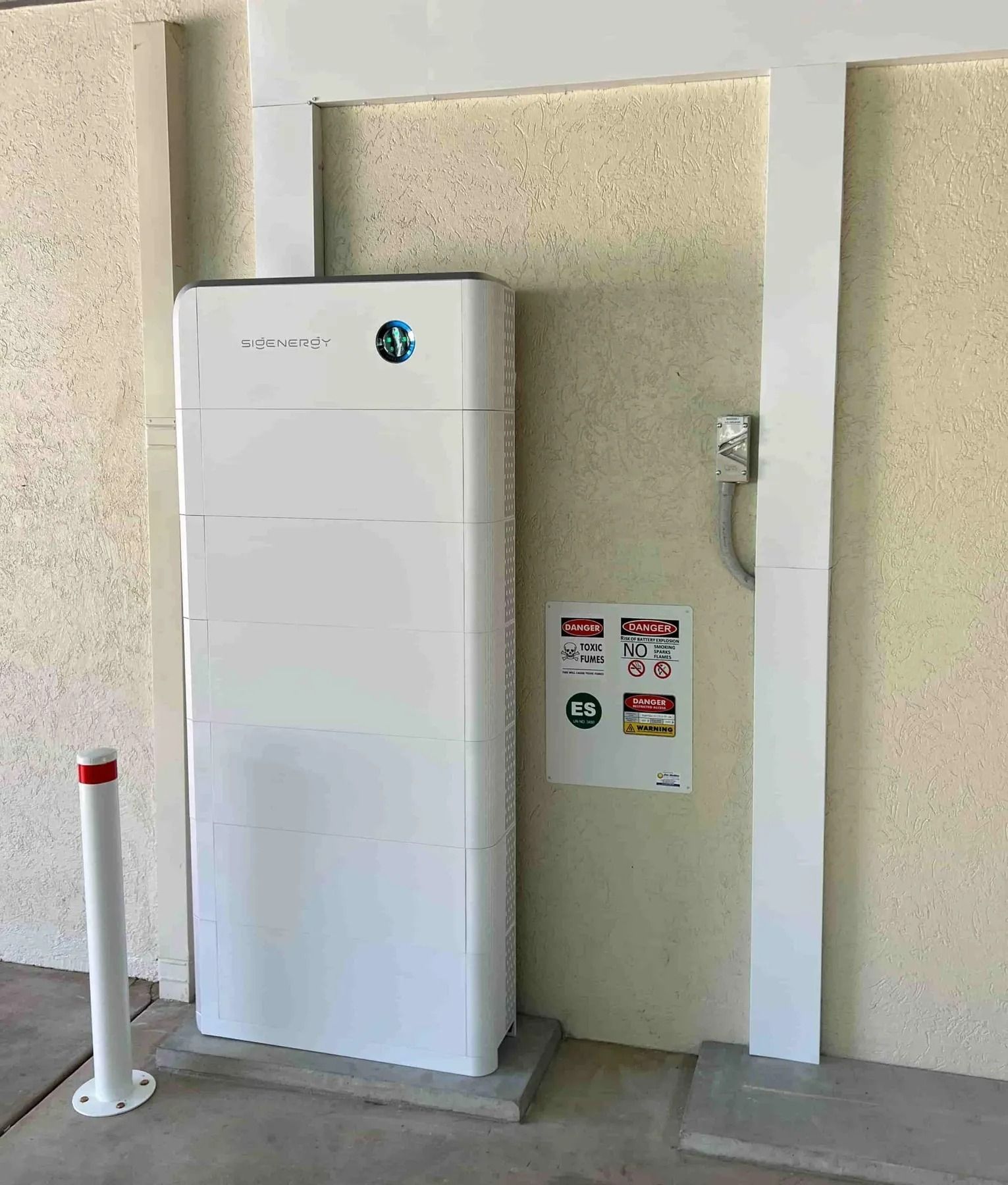 White Energy Storage Unit Mounted on a Concrete Pad — Des Mullins Electrical & Solar in Wagga Wagga, NSW