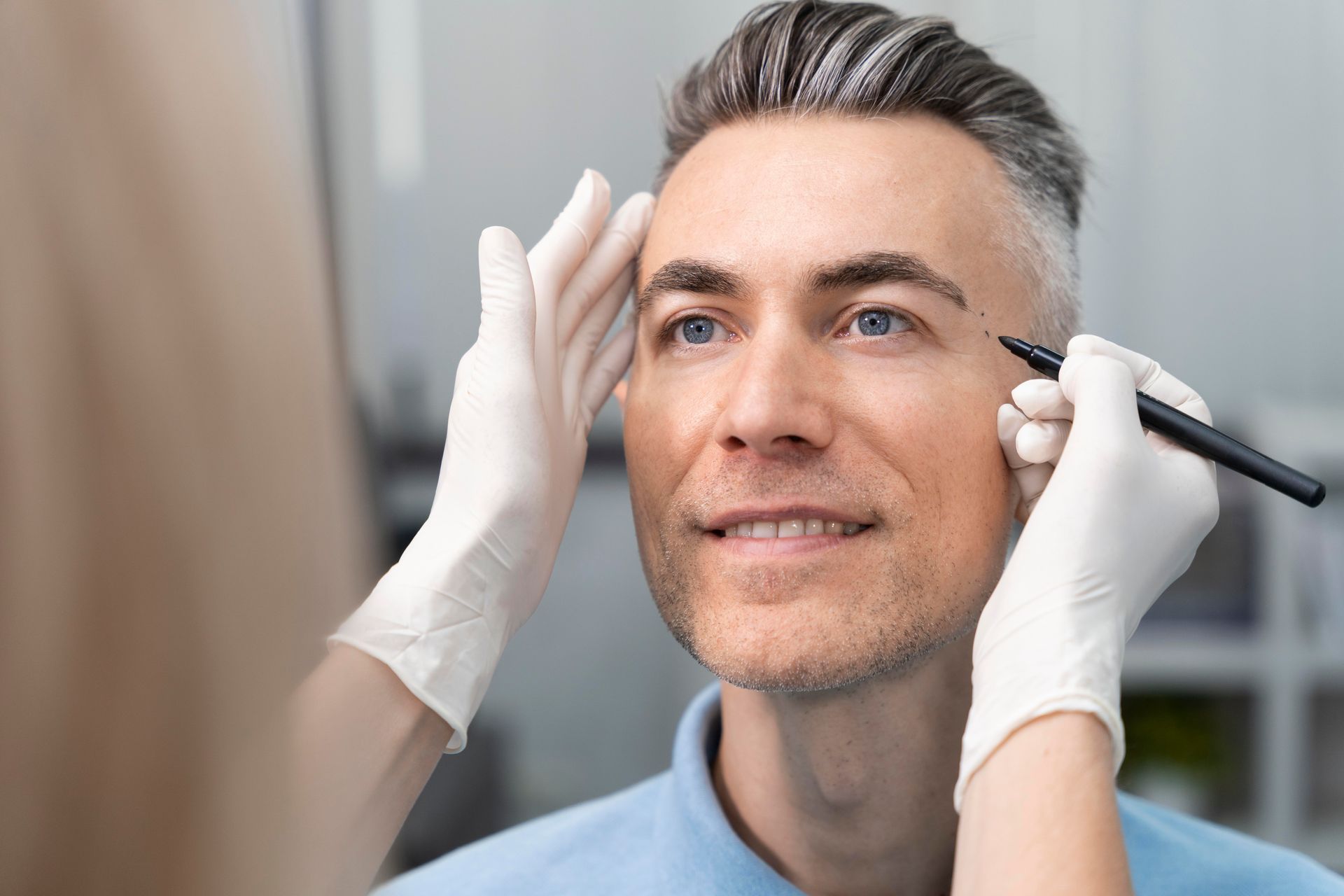 A man is getting a plastic surgery on his face.