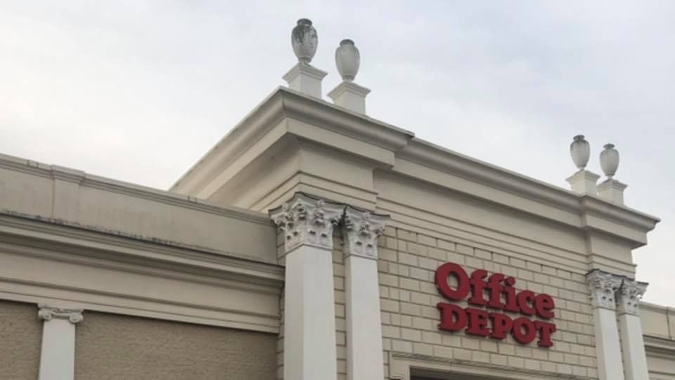Office Depot store exterior with columns, red sign, and architectural details.