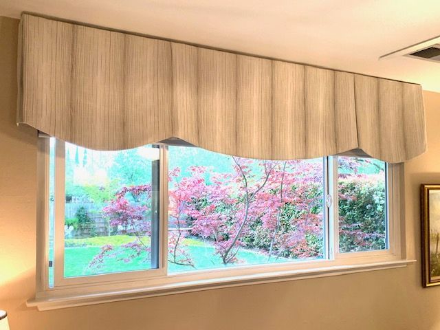 A Living Room with A Large Window and Lamp