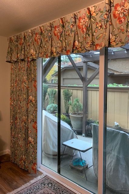 A Living Room with A Sliding Glass Door Leading to A Patio.