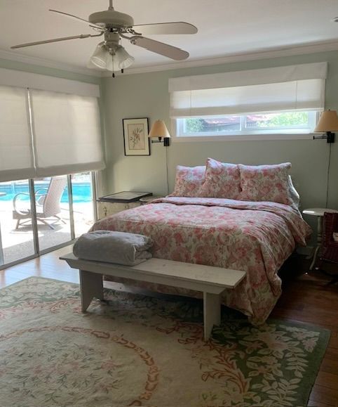 A Bedroom with A Large Bed and A Ceiling Fan.