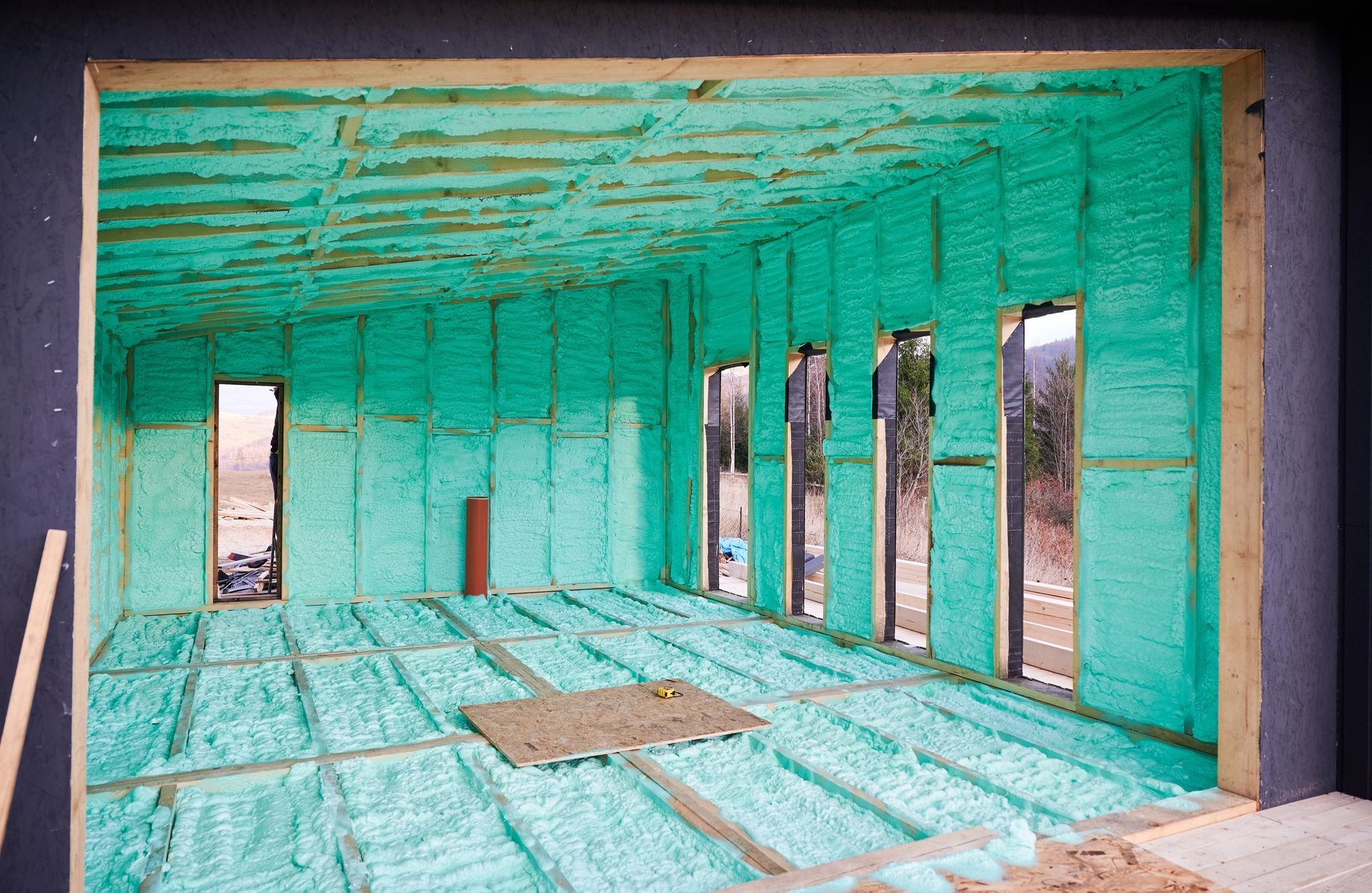 Finished room featuring spray foam insulation throughout the ceiling, walls, and floor at a property in the Gillette area.