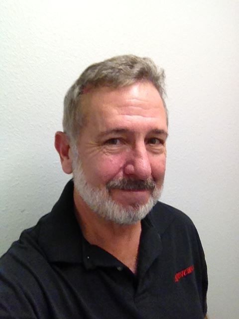 A man with a beard and mustache is wearing a black shirt