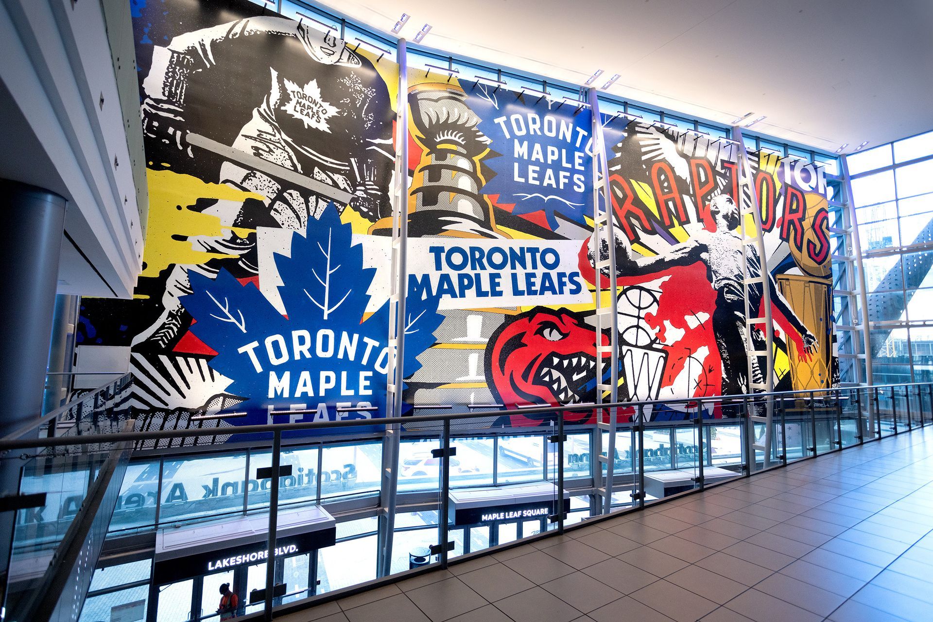 Large wall art featuring logos for Toronto Maple Leafs and Raptors hockey teams.