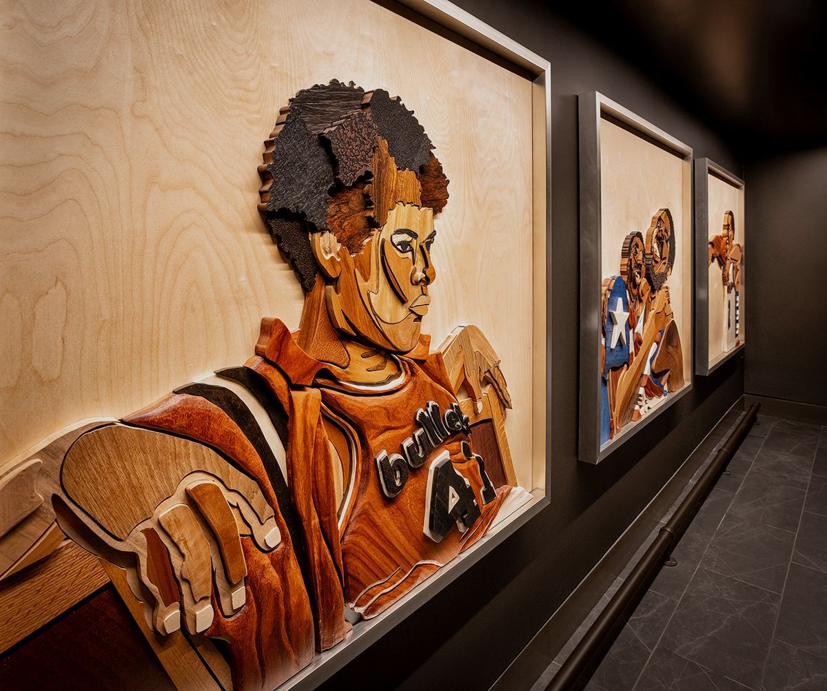 Large colorful mural and seating area in modern building lobby.