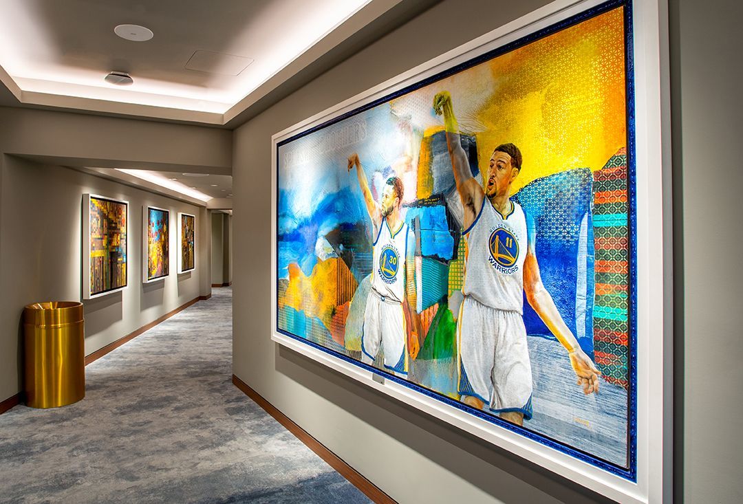 Hallway with large framed artwork of basketball players.
