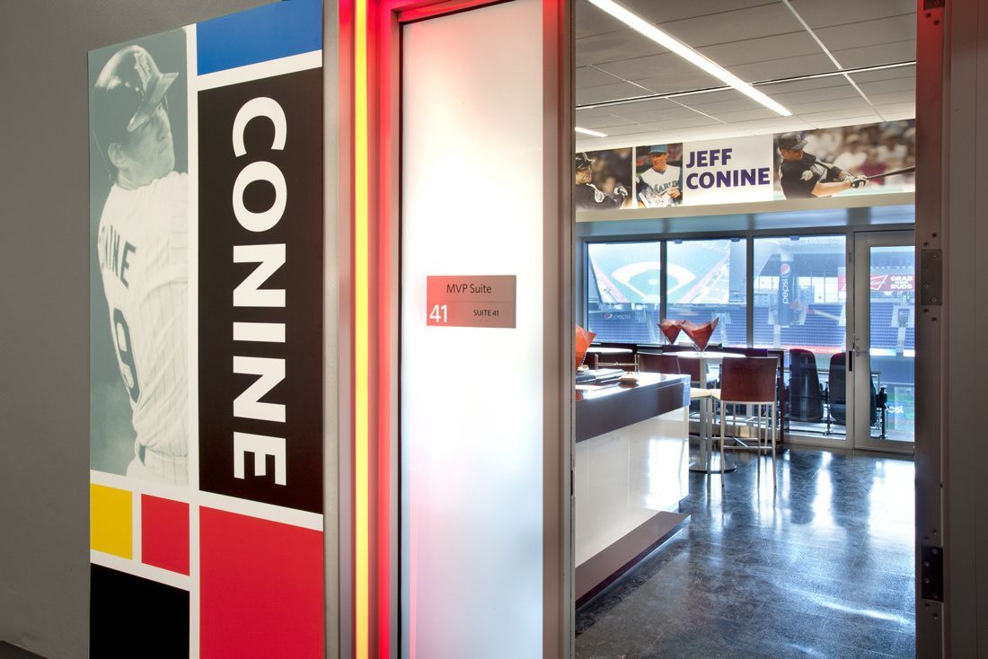 Entrance to Conine club with baseball player image on door. Interior view with table and chairs.