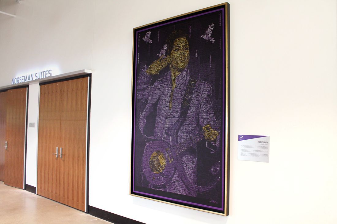 Portrait of a person in a purple suit, made of small purple shapes. It is hanging on a white wall by a door.