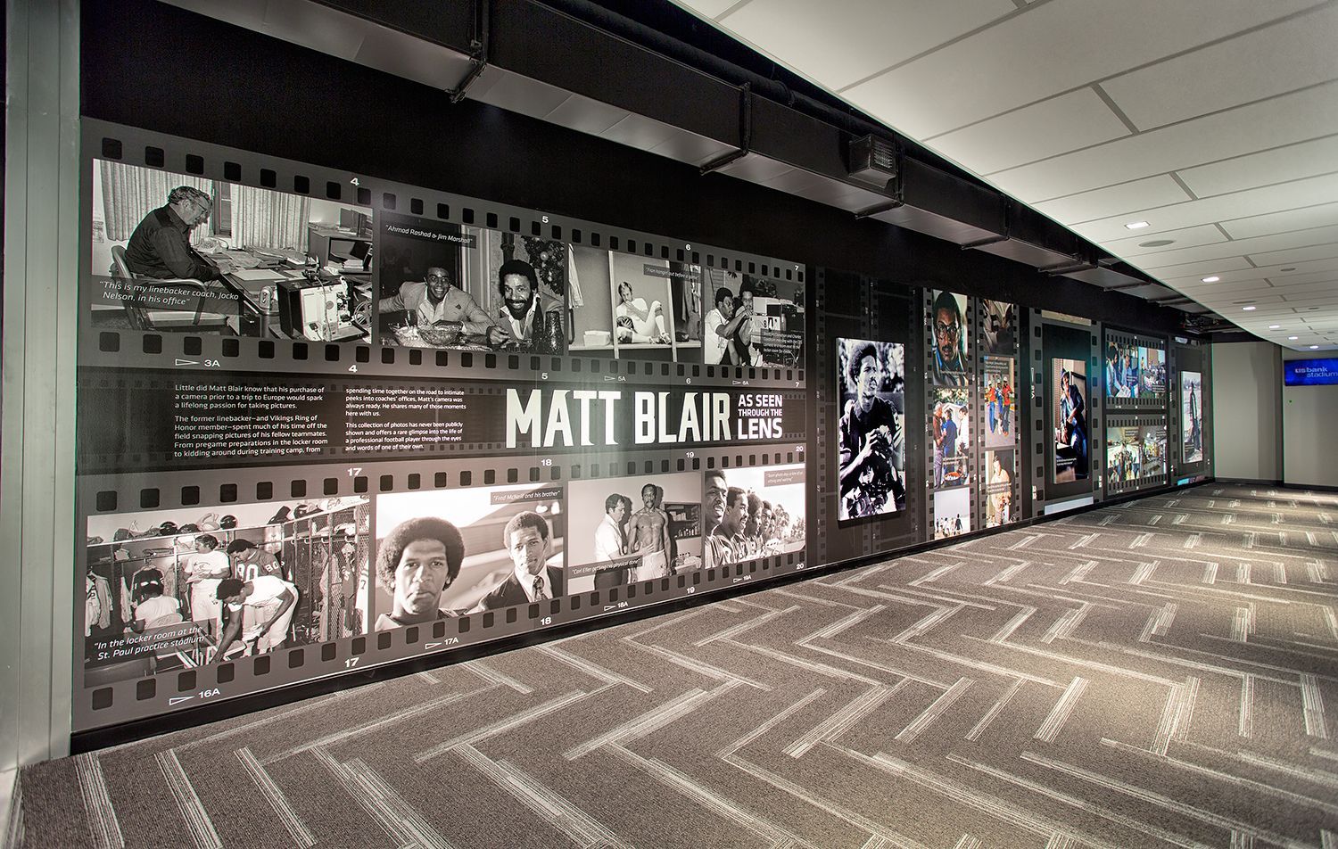 Hallway display with film strip border, photos and text: