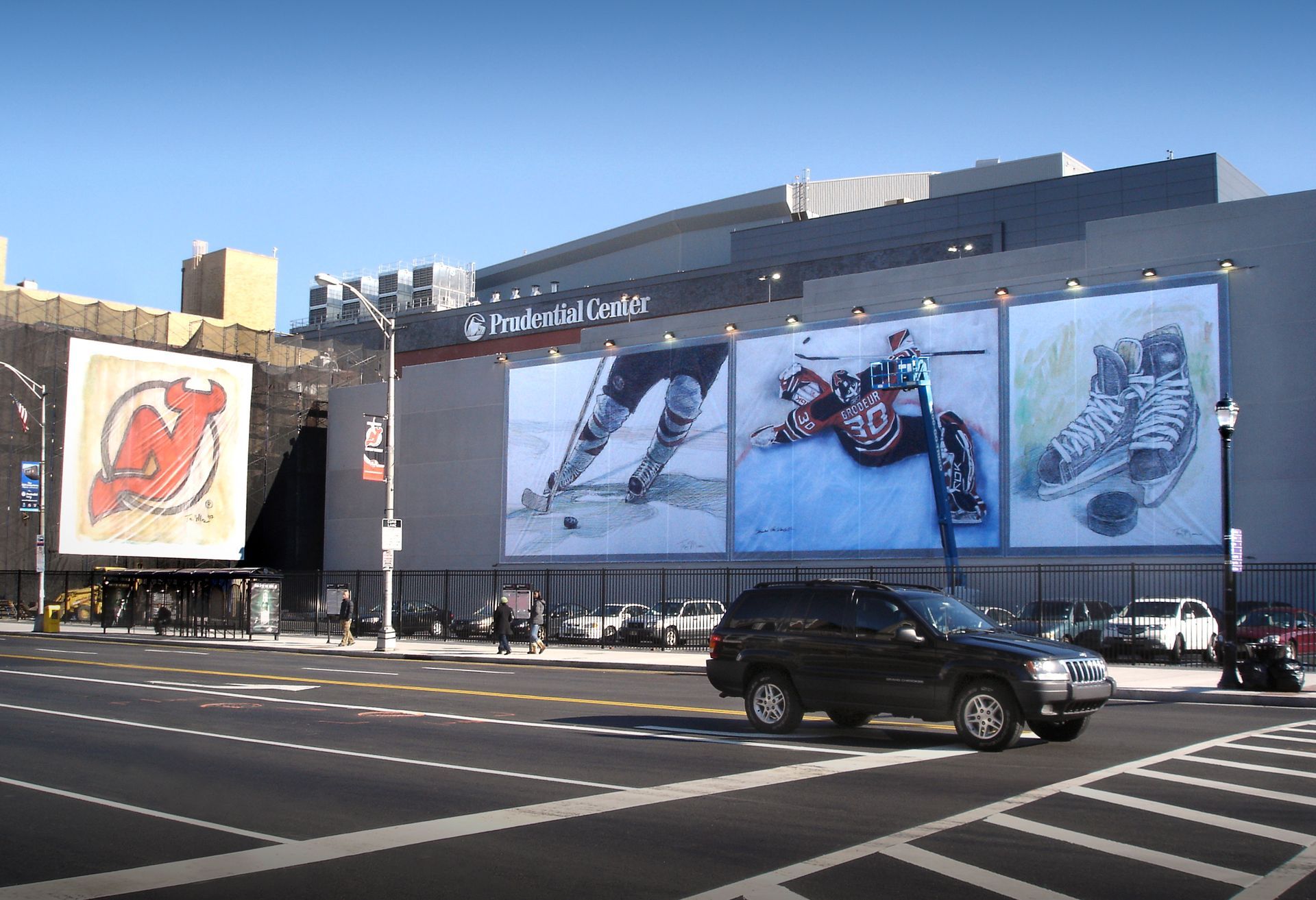 Hallway with black and white wall murals of people, concert scenes, and text.