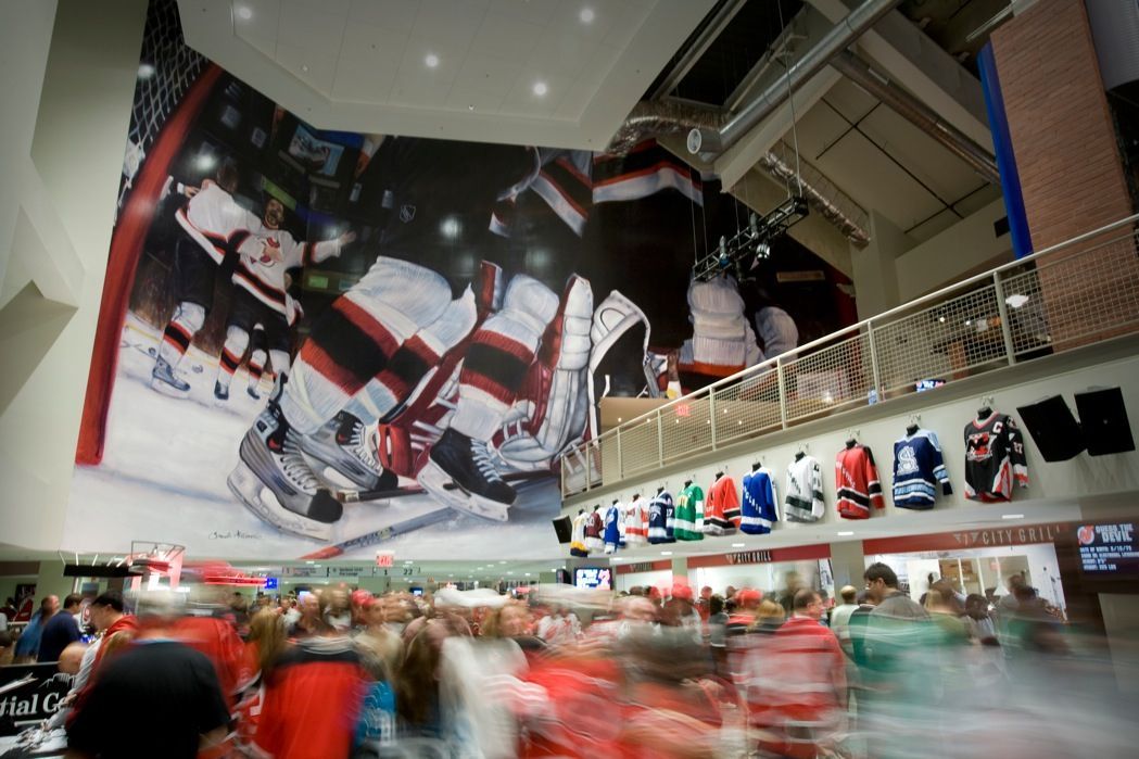 Golden State Warriors logo artwork in a modern, open-plan building.