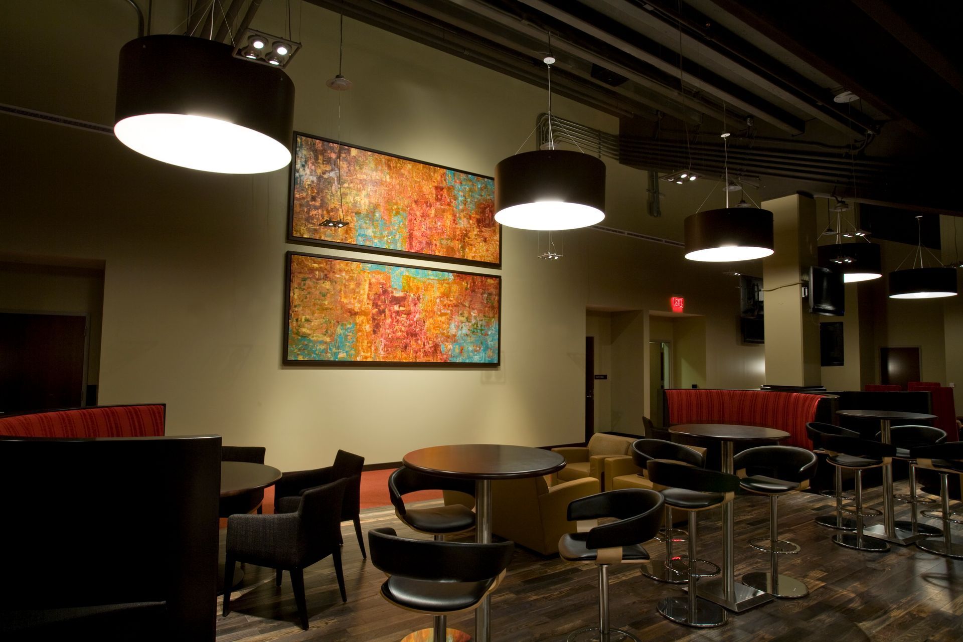 Mural of a person walking, with colorful city buildings. Bright red, blue and yellow design.